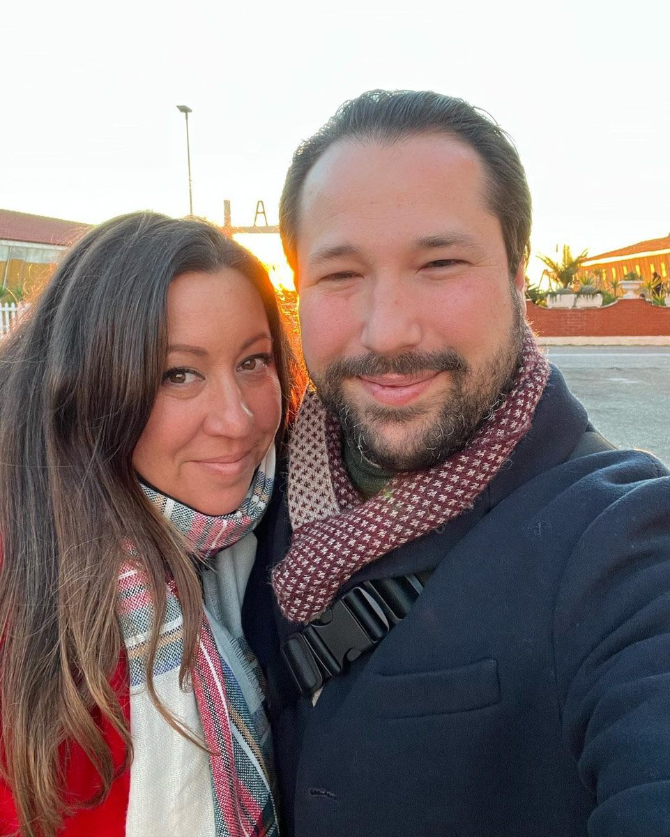 A woman and a man taking a selfie in Viareggio during winter.